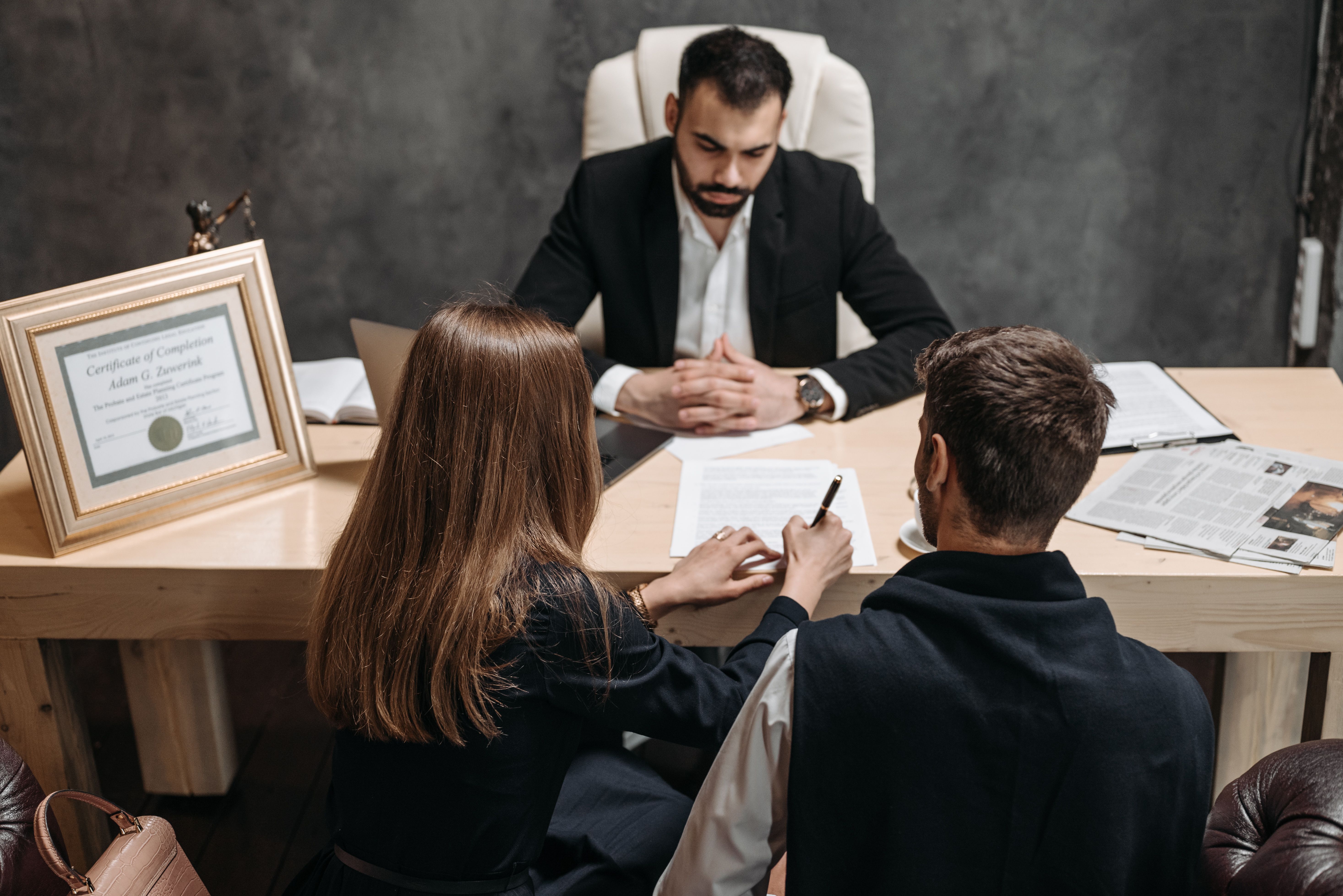 Attorney discussing legal documents with clients in a law office