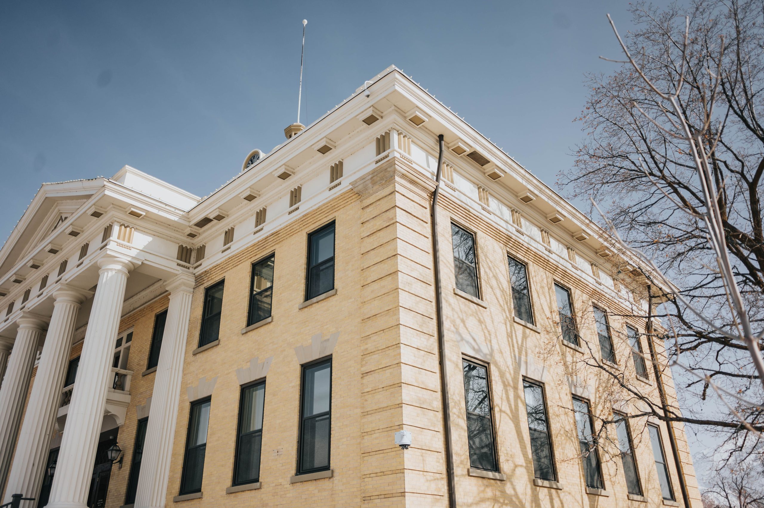 Historic courthouse exterior with columns and blue sky, illustrating where a lawsuit is filed.