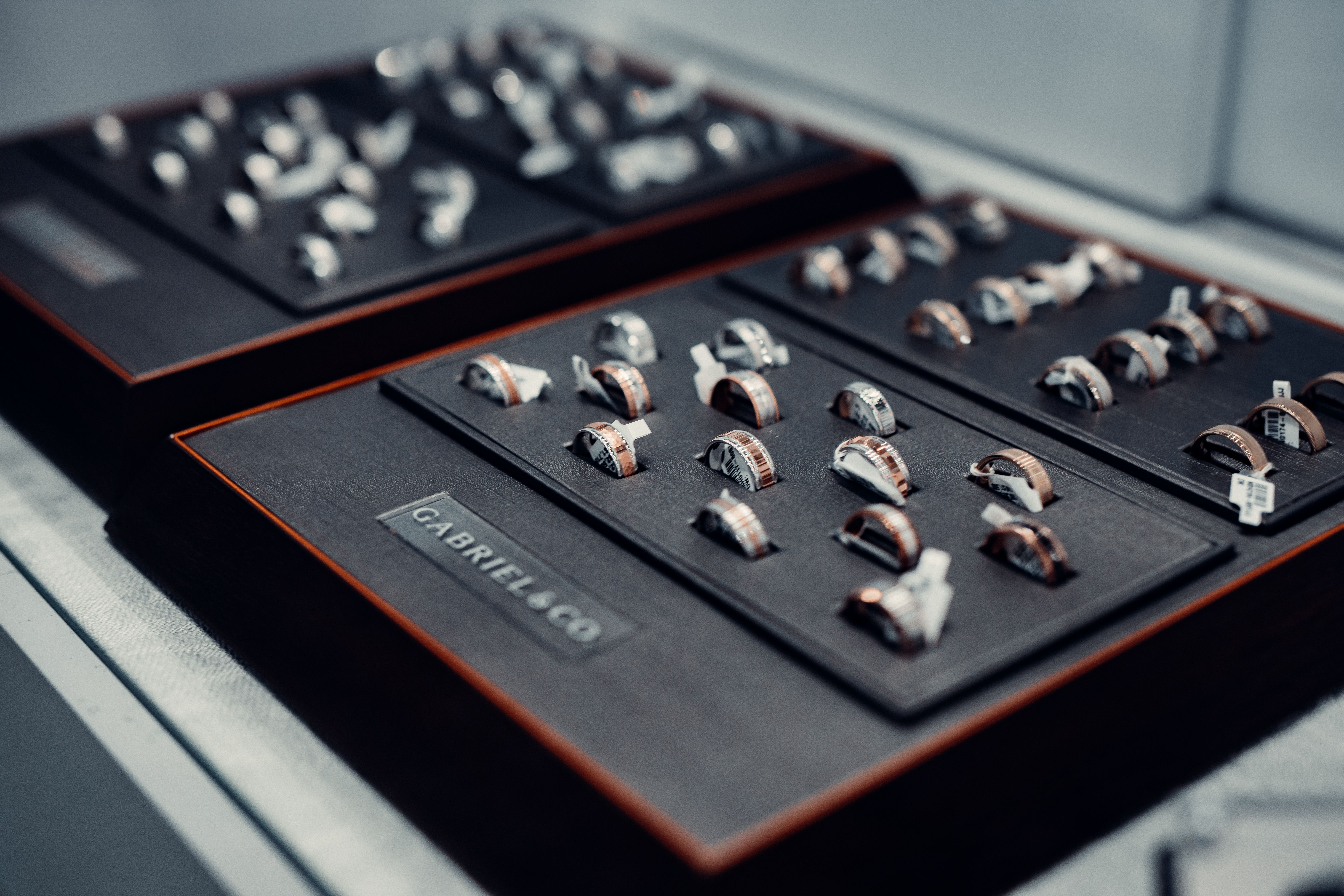 Luxury rings arranged on velvet trays in a jewelry display, illustrating how to compare diamond designs before buying.