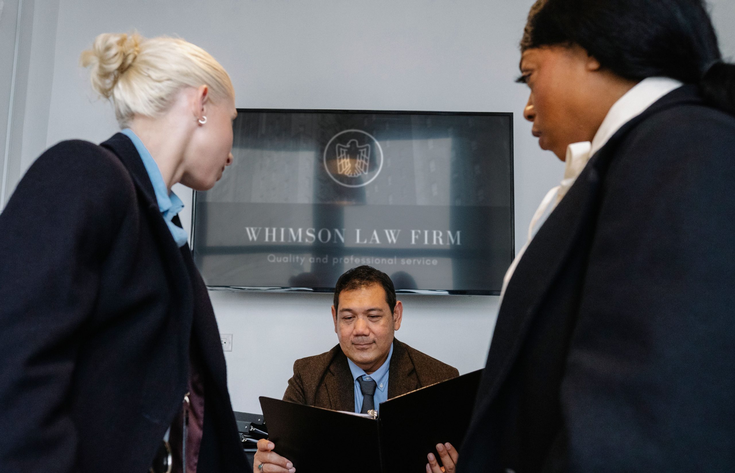 Diverse colleagues gathering in a law firm conference hall to discuss contract details
